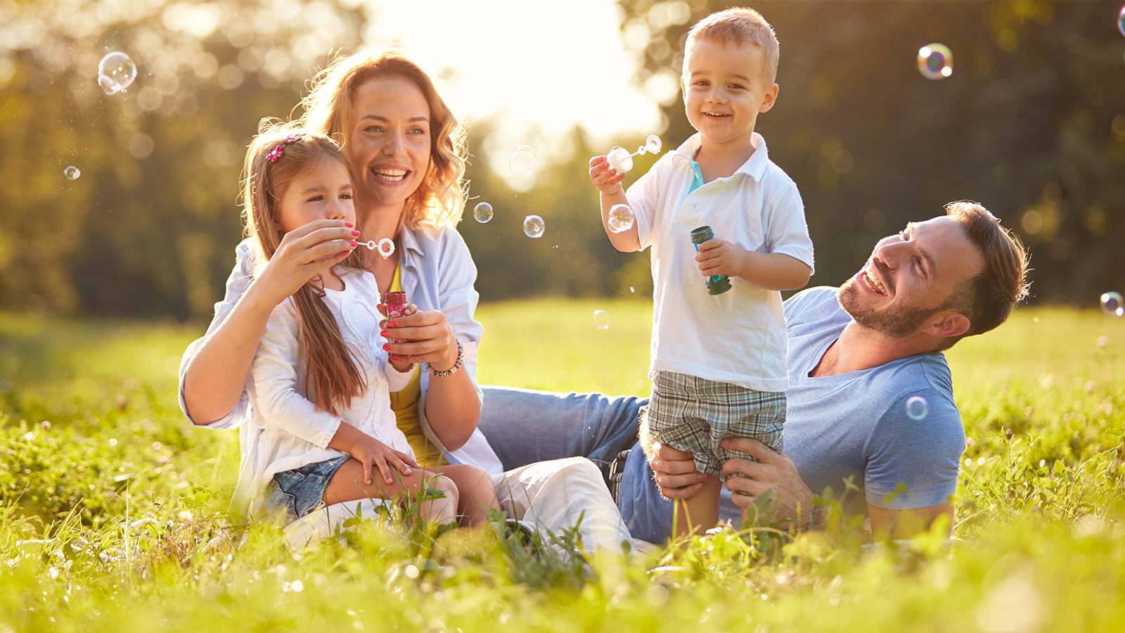 Bellevue Kids Dentist - Family outdoors blowing bubbles